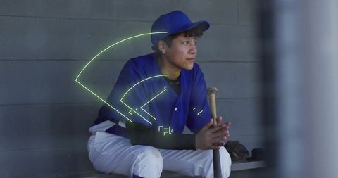 Young Baseball Player Analyzing Field Strategy in Dugout