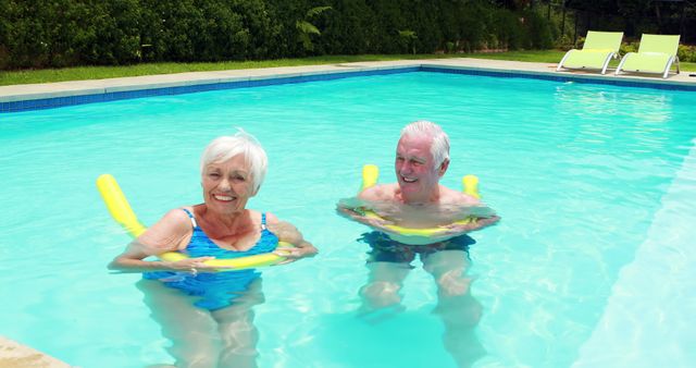 Seniors Enjoying Water Activities in Outdoor Pool on Floating Noodles - Download Free Stock Images Pikwizard.com