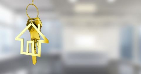 Golden house keychain with modern interior background