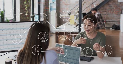 Digital Network Overlay with Colleagues Collaborating in Modern Office