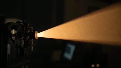 Antique Projector Casting Golden Beam in Darkroom
