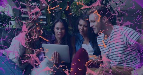 Young Adults Collaborating on Tablet with Digital Network Overlay