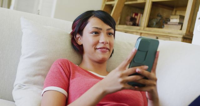 Relaxed Young Woman Texting on Smartphone at Home - Download Free Stock Images Pikwizard.com