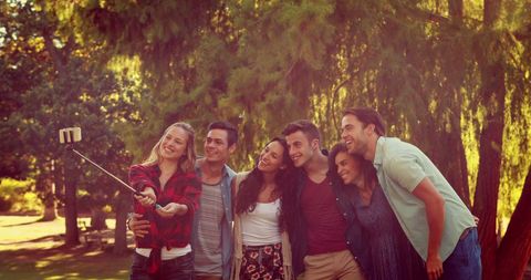 Joyful Friends Taking Selfie in Sunlit Park