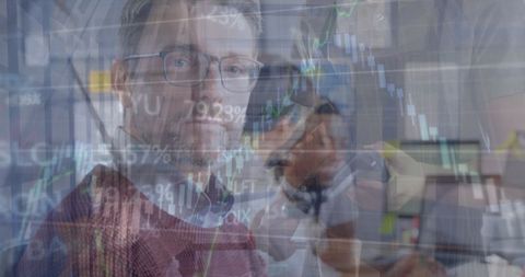 Financial analysts examining real-time stock data on screens