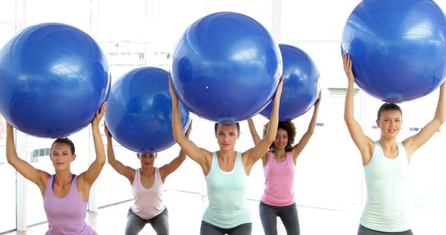 Group of Women Exercising with Fitness Balls in Gym Class - Download Free Stock Images Pikwizard.com