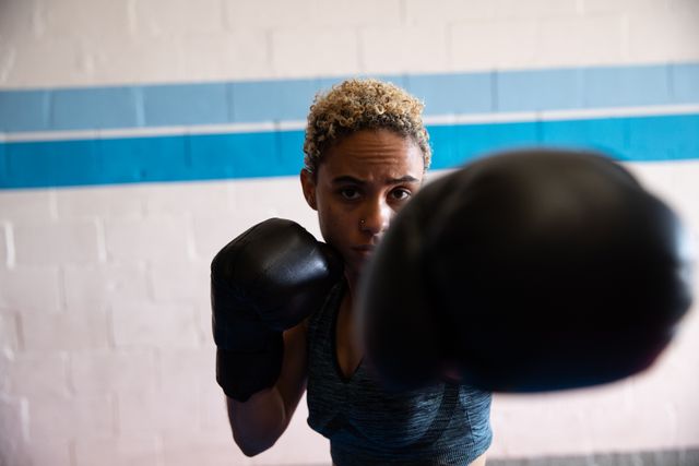Biracial woman practicing box in boxing gym - Download Free Stock Photos Pikwizard.com
