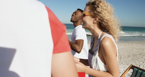 Joyful Friends Enjoying Refreshing Beers at Sunny Beach Gathering