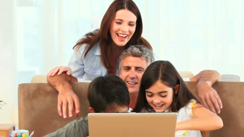 Happy Family Bonding While Using Laptop Together