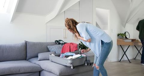 Couple Packing Suitcase for Holiday Leisure and Travel Preparation