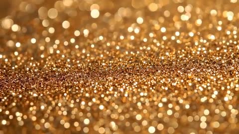 Macro video showing shifting golden glitter bokeh revealing metal flakes and shimmer texture