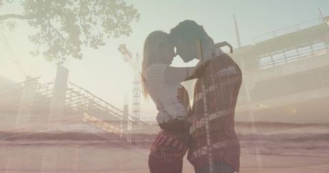 Kissing couple embracing at sunset beach, double exposure blending construction and waves