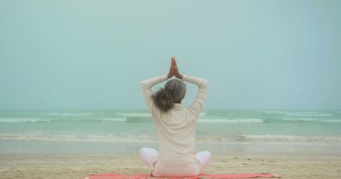 Senior Woman Practicing Yoga Meditation on Serene Beach - Download Free Stock Images Pikwizard.com