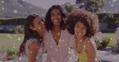 Smiling laughing women hugging poolside enjoying sunny backyard celebration bokeh