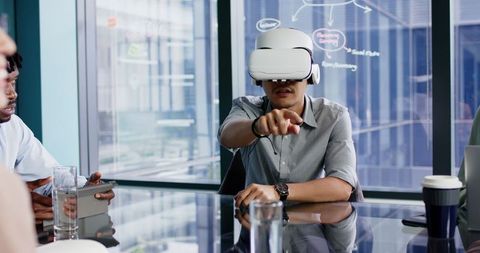 Businessman Engaging in Virtual Reality during Office Meeting