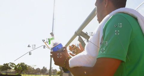 Athlete resting on bleachers holding water bottle with futuristic performance hud overlay