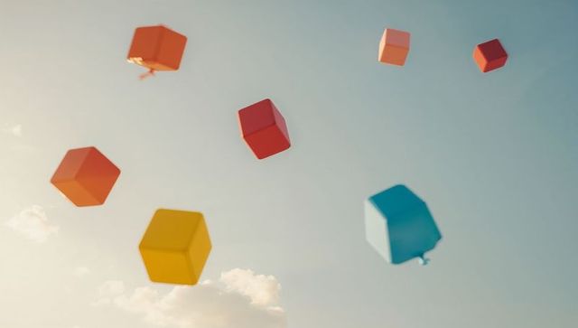 Vibrant geometric floating balloons against blue sky