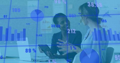 Businesswomen Collaborating and Analyzing Data Visualizations on Digital Dashboard