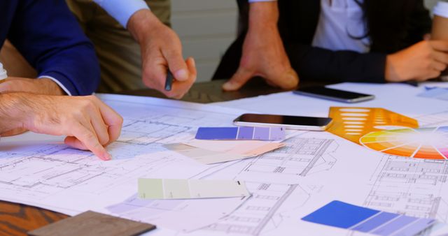 Architects Collaborating on Building Blueprint with Color Swatches - Download Free Stock Images Pikwizard.com