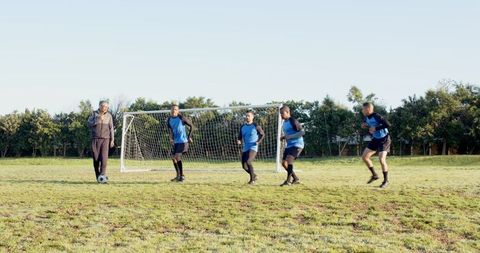 Youth Soccer Team Practicing Drills on Outdoor Field