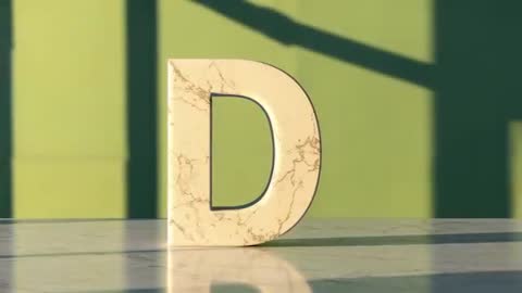 Artistic Display of Marble Letter D on Sunlit Desk