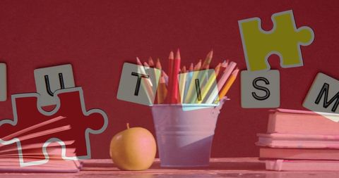 Autism awareness concept with puzzles and school supplies