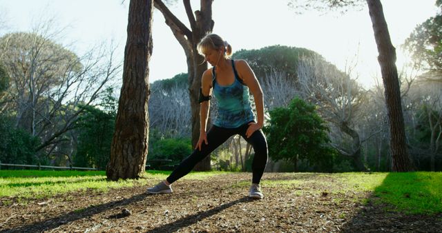 Fit woman stretching and exercising in serene outdoor park - Download Free Stock Images Pikwizard.com