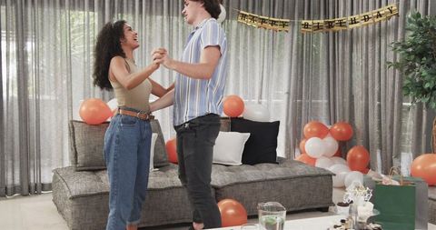 Couple Celebrating Birthday with Dance in Decorated Living Room