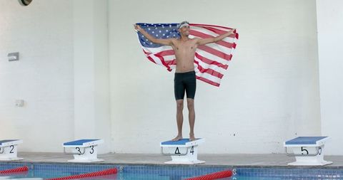 Triumphant Young Swimmer Celebrates with American Flag
