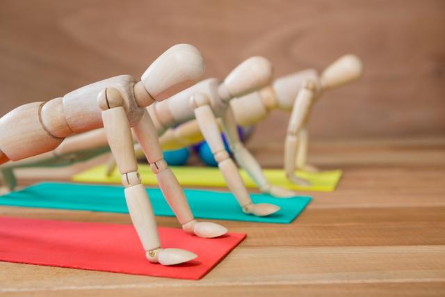 Conceptual image of figurines performing pushups exercise