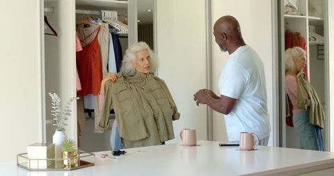 Senior couple choosing clothes in walk-in closet