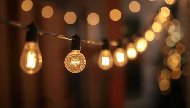Vintage string lights casting golden bokeh and cozy patio evening ambiance