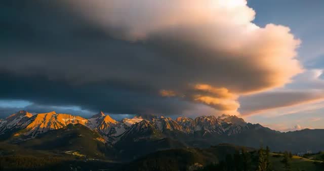 Mesmerizing Clouds Sweeping Over Majestic Snow-capped Peaks