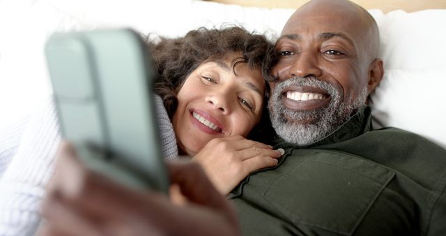 Happy Couple Relaxing in Bed and Using Smartphone - Download Free Stock Images Pikwizard.com