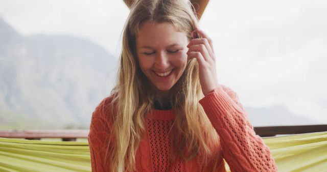 Smiling Young Woman Relaxing Outdoors in Cozy Sweater - Download Free Stock Images Pikwizard.com