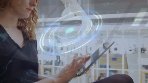 Woman tapping tablet while AR analytics overlay visualizing business data in open office