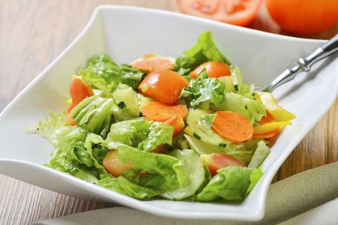 Fresh garden salad with crisp lettuce, cherry tomatoes, cucumber and carrot slices