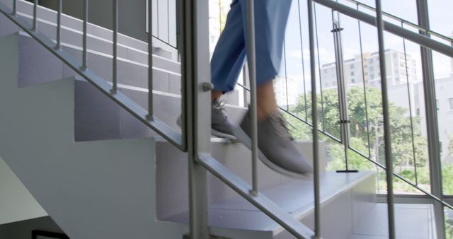 Business Professional Walking Downstairs in Modern Building - Download Free Stock Images Pikwizard.com