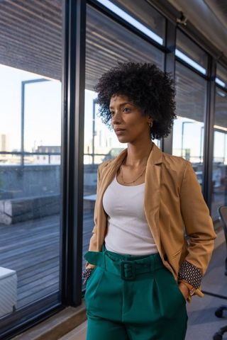 Confident Woman in Modern Office with City Skyline View