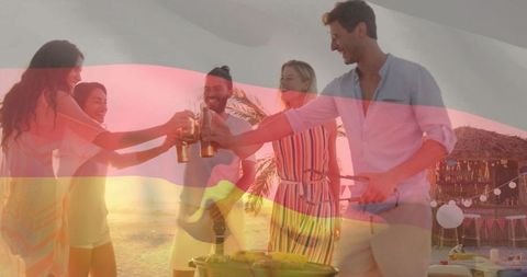 Friends Celebrating at Beach Barbecue Party at Sunset