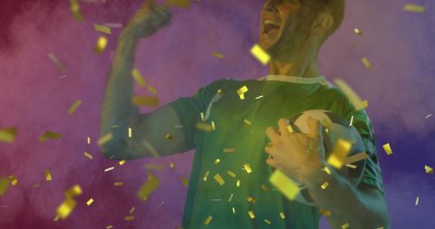 Excited Male Soccer Fan Holding Ball with Gold Confetti Celebration