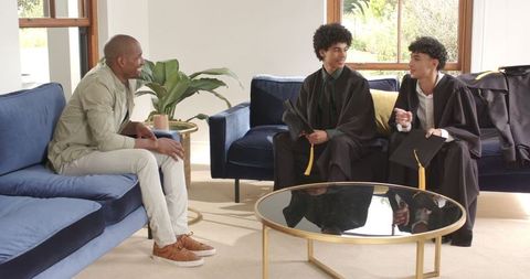 Proud Father Celebrating Sons' Graduation at Family Home