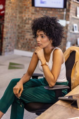 Young businesswoman contemplating ideas in modern office