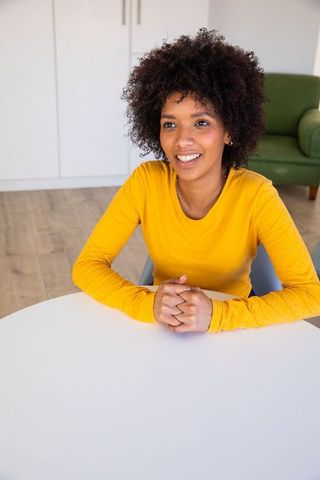Smiling African American Woman Seated in Modern Home Environment
