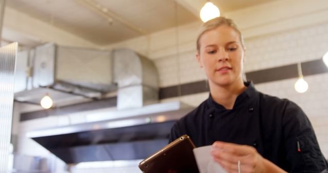 Chef Holding Digital Tablet, Checking Order in Commercial Kitchen - Download Free Stock Images Pikwizard.com