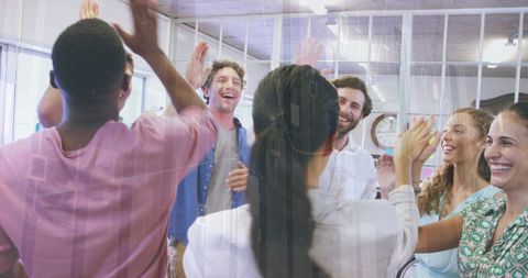 Diverse Team Celebrating Business Success in Modern Office