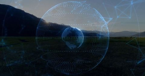 Holographic globe over grassy plain at sunset illustrating futuristic connectivity