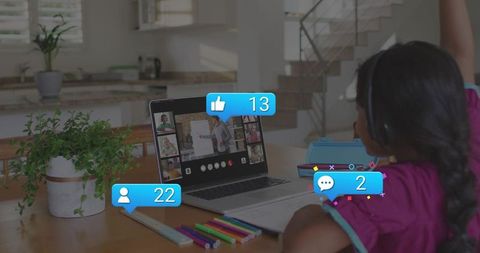 Girl raising hand in virtual classroom on laptop at home study table with headphones