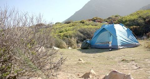 Blue Tent Camping Adventure in Mountain Wilderness