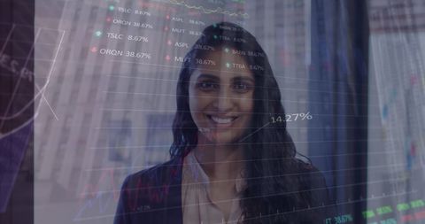 Smiling businesswoman analyzing stock market trends in office